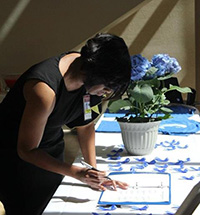 Doctor signing a form at Children's Advocacy Centers of Georgia event.
